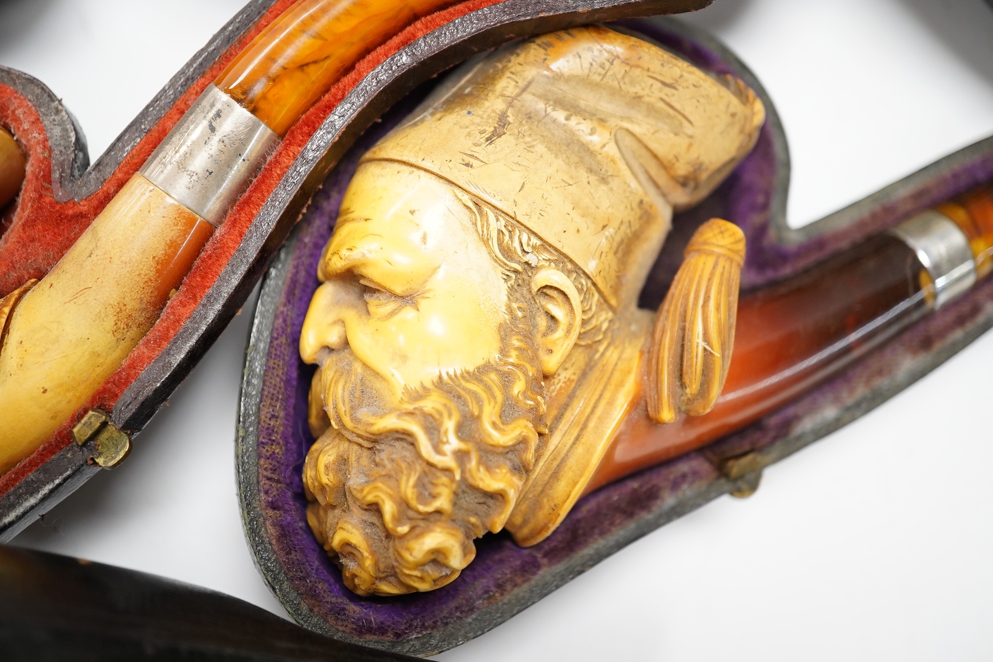 Three cased assorted Meerschaum pipes; sailor, boy on a pole and a Turk, largest Turk 19cm long. Condition - all pipes have damage either in pipe bowls or amber, cases worn